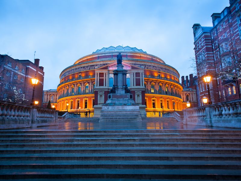Steps leading up to the Royal Albert Hall Opera theater in London, England, at dusk.